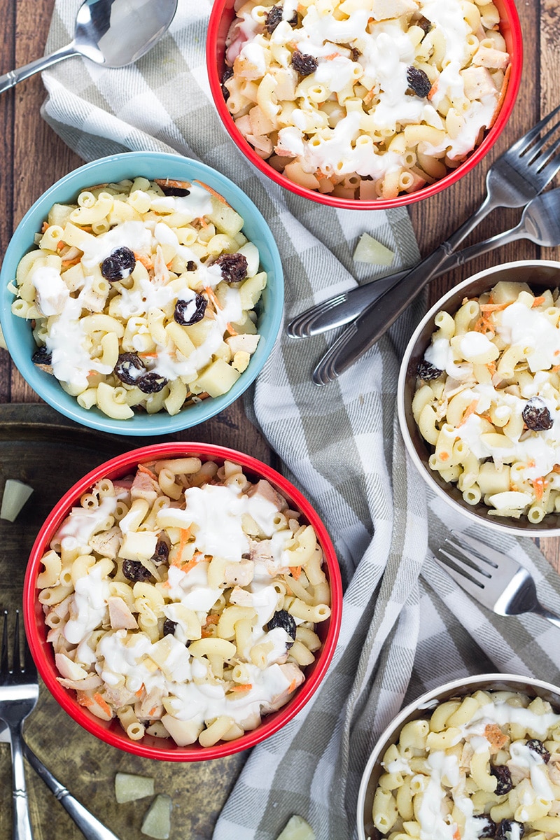 This Filipino Macaroni Salad is not the one you are used to. It features pineapple, raisins, and condensed milk. Mildly sweet, creamy, comforting - you'll love it! | cookingtheglobe.com