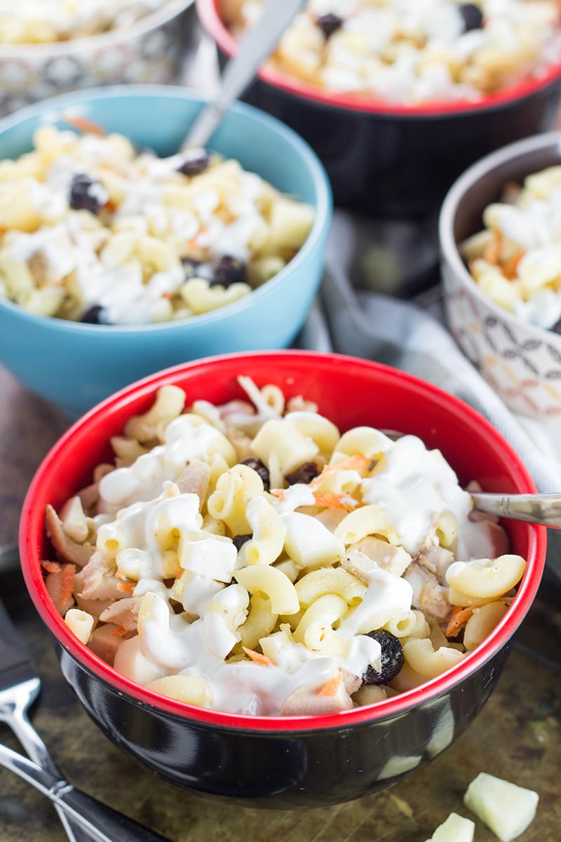 This Filipino Macaroni Salad is not the one you are used to. It features pineapple, raisins, and condensed milk. Mildly sweet, creamy, comforting - you'll love it! | cookingtheglobe.com