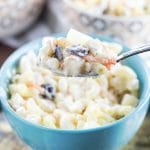 This Filipino Macaroni Salad is not the one you are used to. It features pineapple, raisins, and condensed milk. Mildly sweet, creamy, comforting - you'll love it! | cookingtheglobe.com