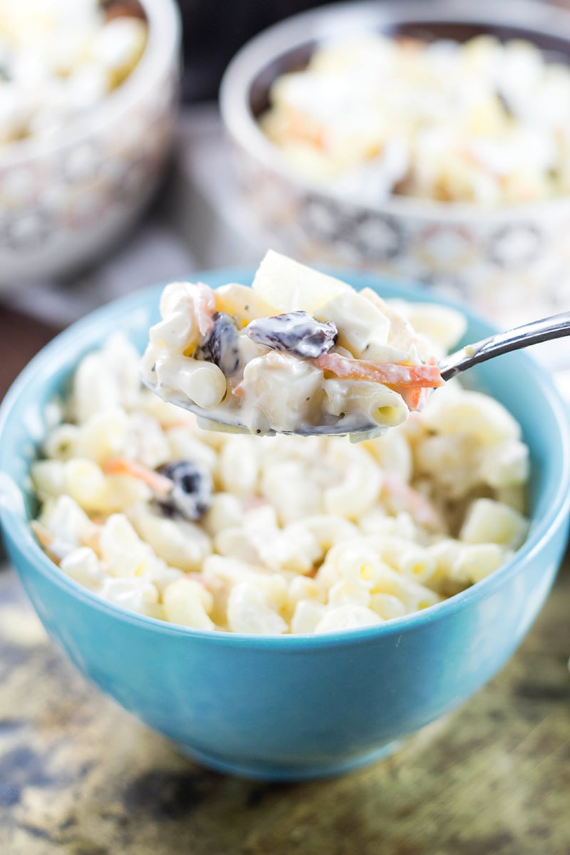 This Filipino Macaroni Salad is not the one you are used to. It features pineapple, raisins, and condensed milk. Mildly sweet, creamy, comforting - you'll love it! | cookingtheglobe.com