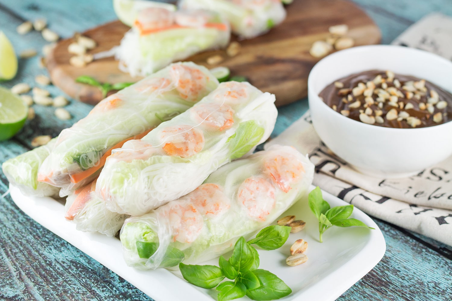 These fresh Vietnamese Spring Rolls (Goi Cuon) are stuffed with pork, shrimp, veggies, and rolled with rice paper. Served with crazy delicious peanut sauce, they make a perfect appetizer or snack! | cookingtheglobe.com