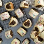 These Italian Christmas Cookies, also called Cuccidati, are filled with a mouth-watering fig and walnut mixture and topped with a sweet white icing! | cookingtheglobe.com