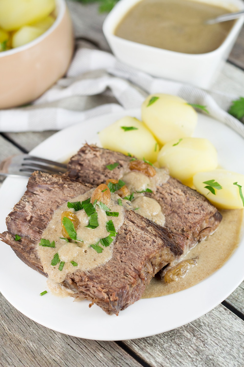Sauerbraten is a signature German dish often served on Christmas. It's the fork-tender pot roast drowned in a fantastic sweet & sour gravy! | cookingtheglobe.com
