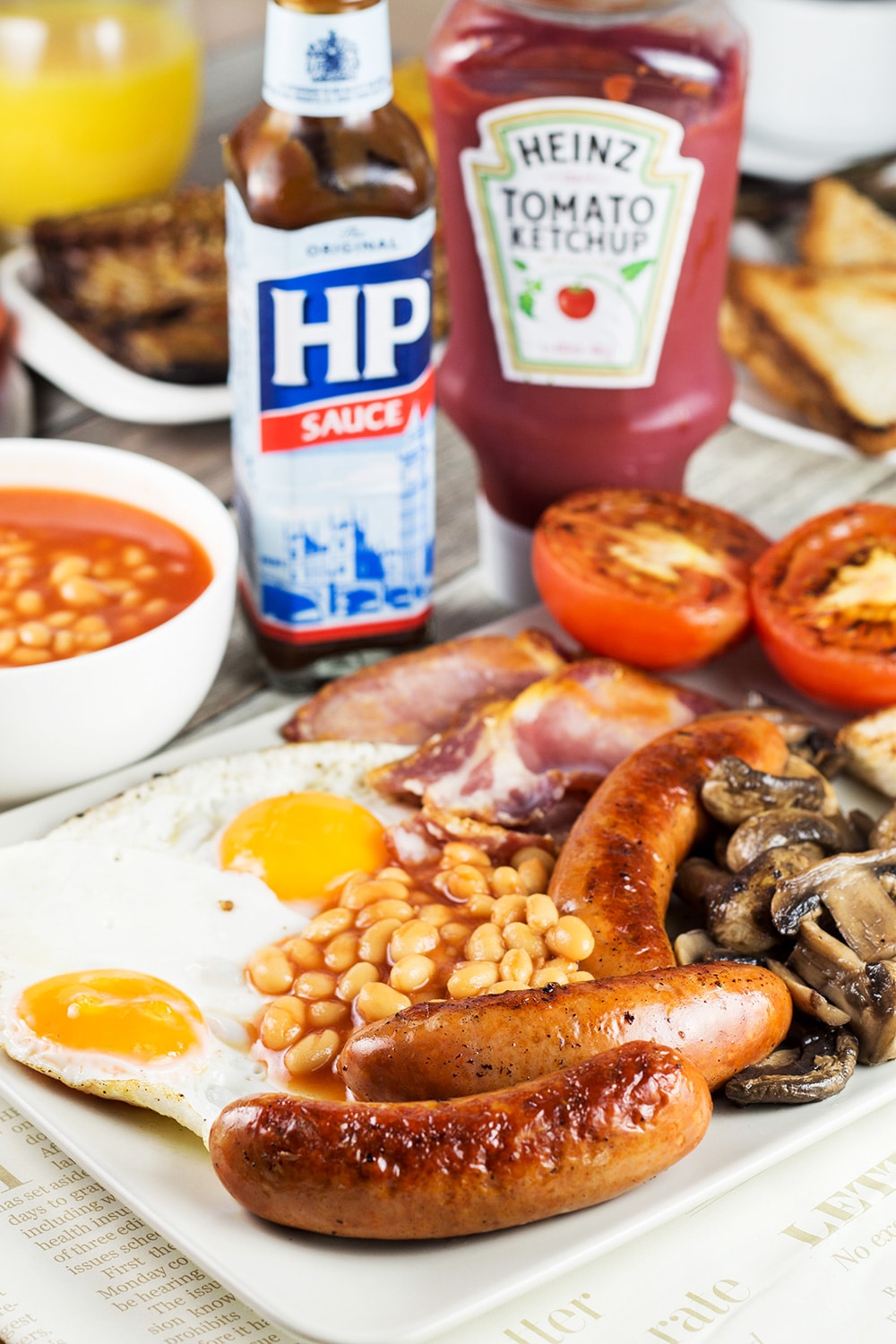 A look at the most iconic morning fare in the world - English breakfast. This hearty meal features eggs, sausages, bacon, beans, mushrooms, and more! | cookingtheglobe.com