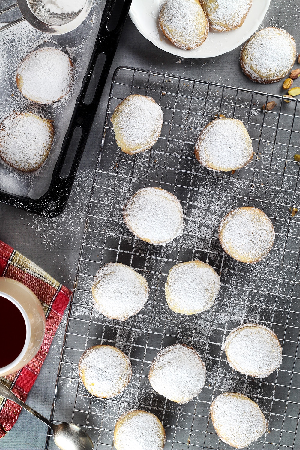 These Greek Butter Cookies (Kourabiedes) are usually made on Christmas or other holidays. They are tender, buttery, and stuffed with pistachios! | cookingtheglobe.com