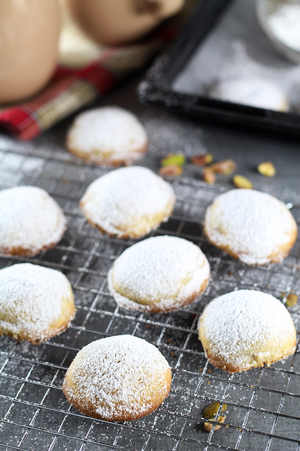 These Greek Butter Cookies (Kourabiedes) are usually made on Christmas or other holidays. They are tender, buttery, and stuffed with pistachios! | cookingtheglobe.com