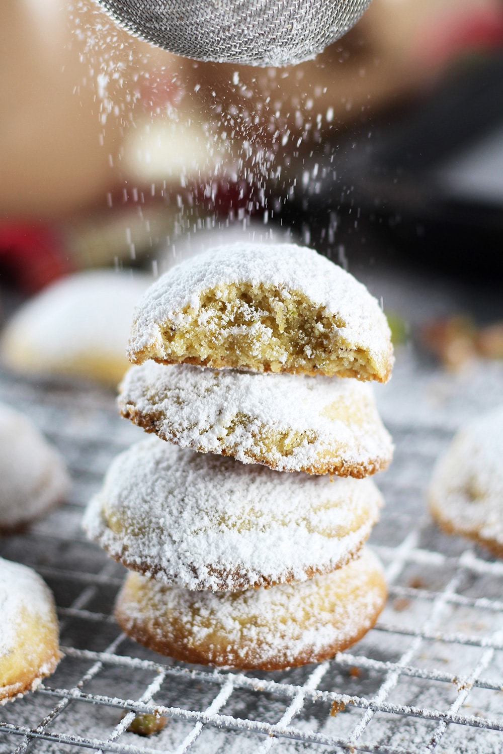 These Greek Butter Cookies (Kourabiedes) are usually made on Christmas or other holidays. They are tender, buttery, and stuffed with pistachios! | cookingtheglobe.com
