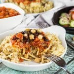 Koshari, or lentils and rice, is a national Egyptian dish. It also features pasta, chickpeas, fried onions, and a homemade tomato sauce. Healthy, filling, nutritious! #vegetarian #vegan| cookingtheglobe.com
