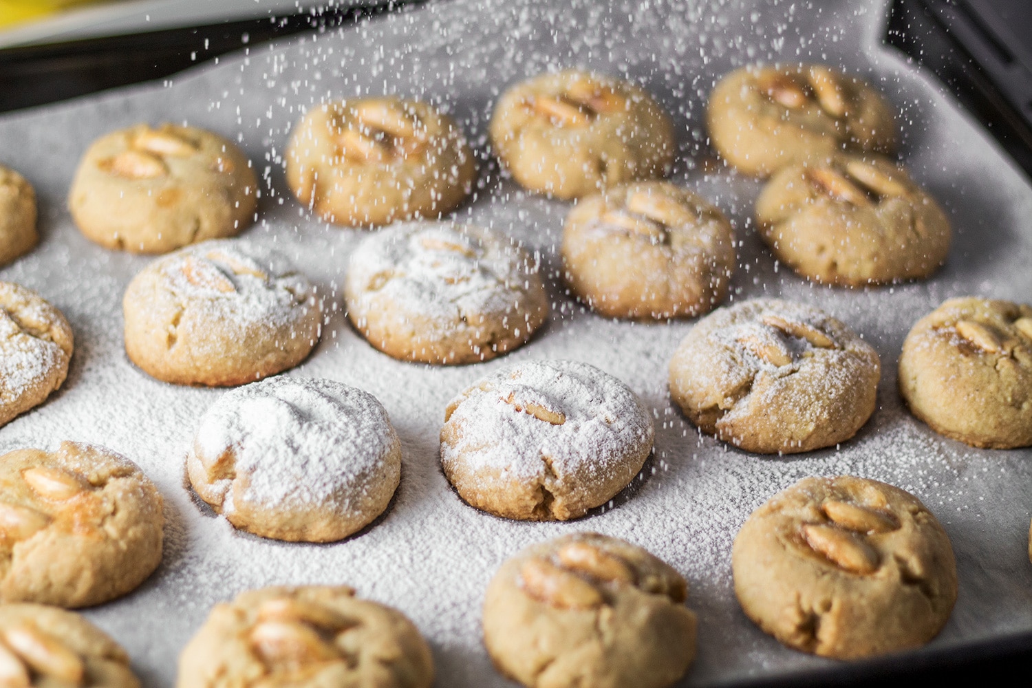 These Mexican Wedding Cookies are buttery, crumbly, nutty, and topped with whole almonds. Perfect with a mug of hot cocoa or a cup of milk, tea, or coffee! | cookingtheglobe.com