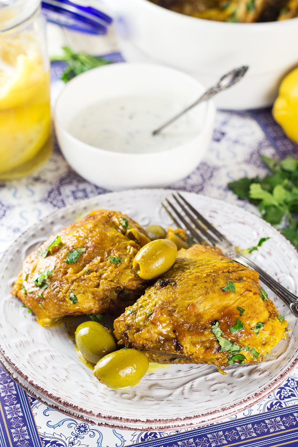 This Moroccan Chicken Tagine is bursting with flavor! Infused with saffron and flavored with preserved lemons, it's guaranteed to become your favorite! | cookingtheglobe.com