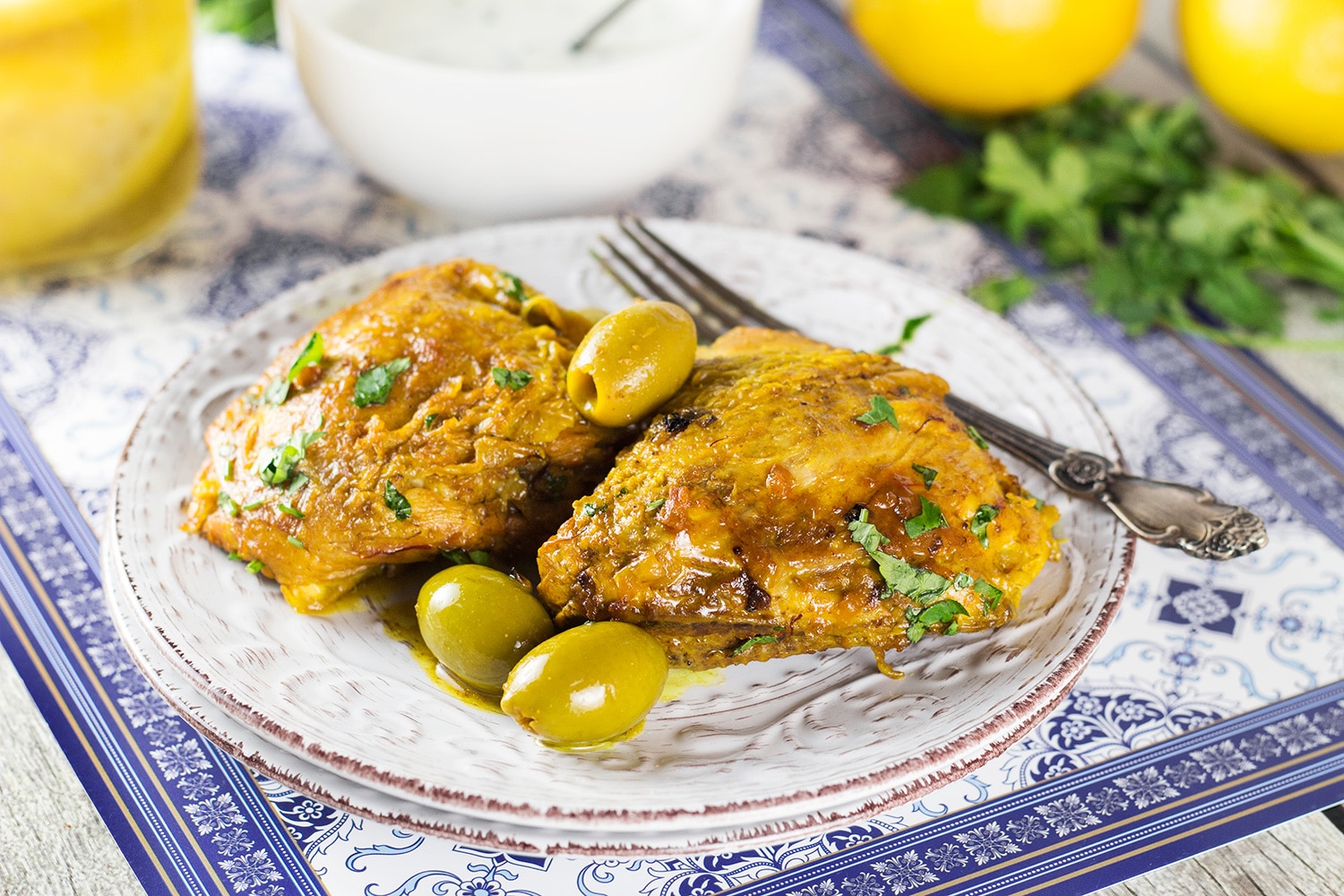 This Moroccan Chicken Tagine is bursting with flavor! Infused with saffron and flavored with preserved lemons, it's guaranteed to become your favorite! | cookingtheglobe.com