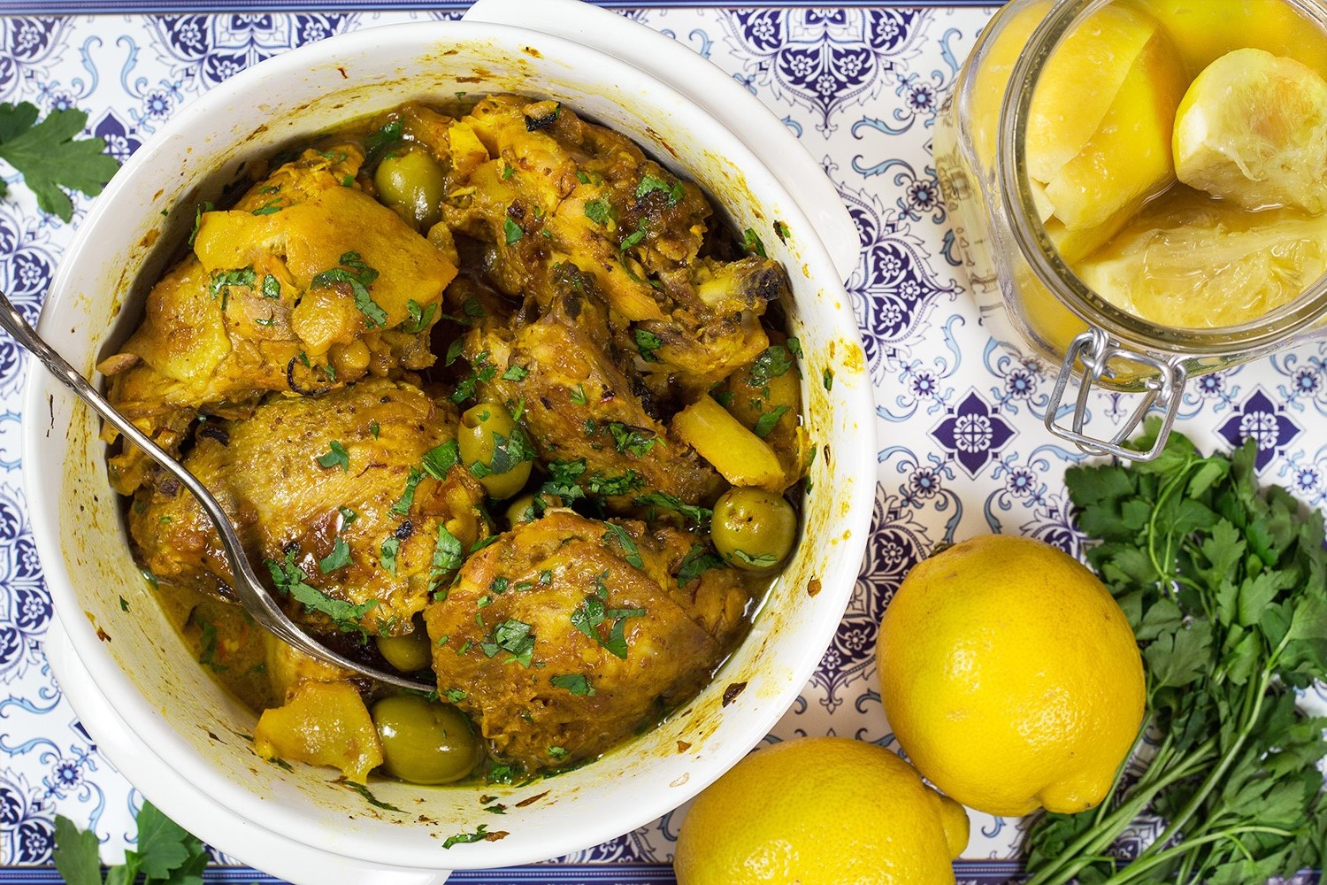 This Moroccan Chicken Tagine is bursting with flavor! Infused with saffron and flavored with preserved lemons, it's guaranteed to become your favorite! | cookingtheglobe.com