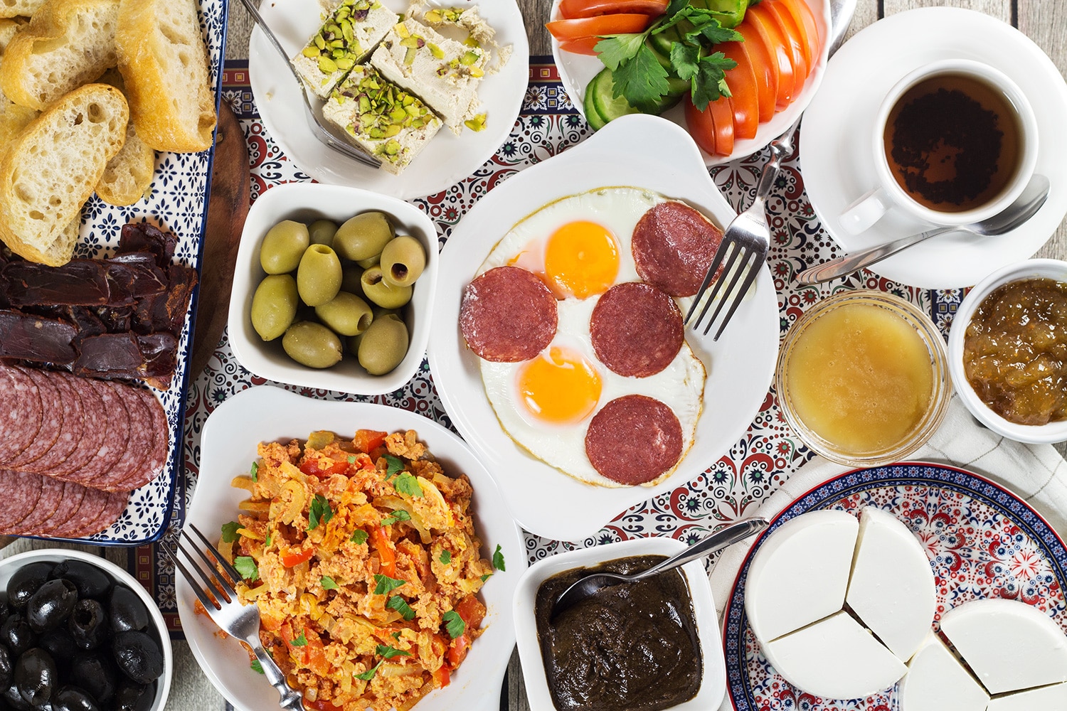 A look at the generous Turkish breakfast which features fresh bread, pastries, cold cuts, eggs, spreads, jams, cheese, veggies, and more! | cookingtheglobe.com
