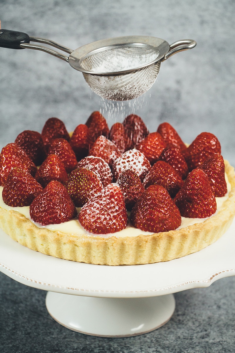 This French Strawberry Tart is literally the best thing you can make with fresh full-of-flavor strawberries. A buttery tart shell + custard + strawberries! | cookingtheglobe.com