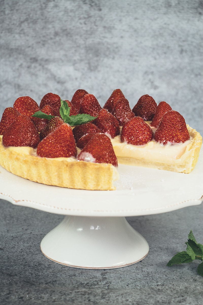 This French Strawberry Tart is literally the best thing you can make with fresh full-of-flavor strawberries. A buttery tart shell + custard + strawberries! | cookingtheglobe.com