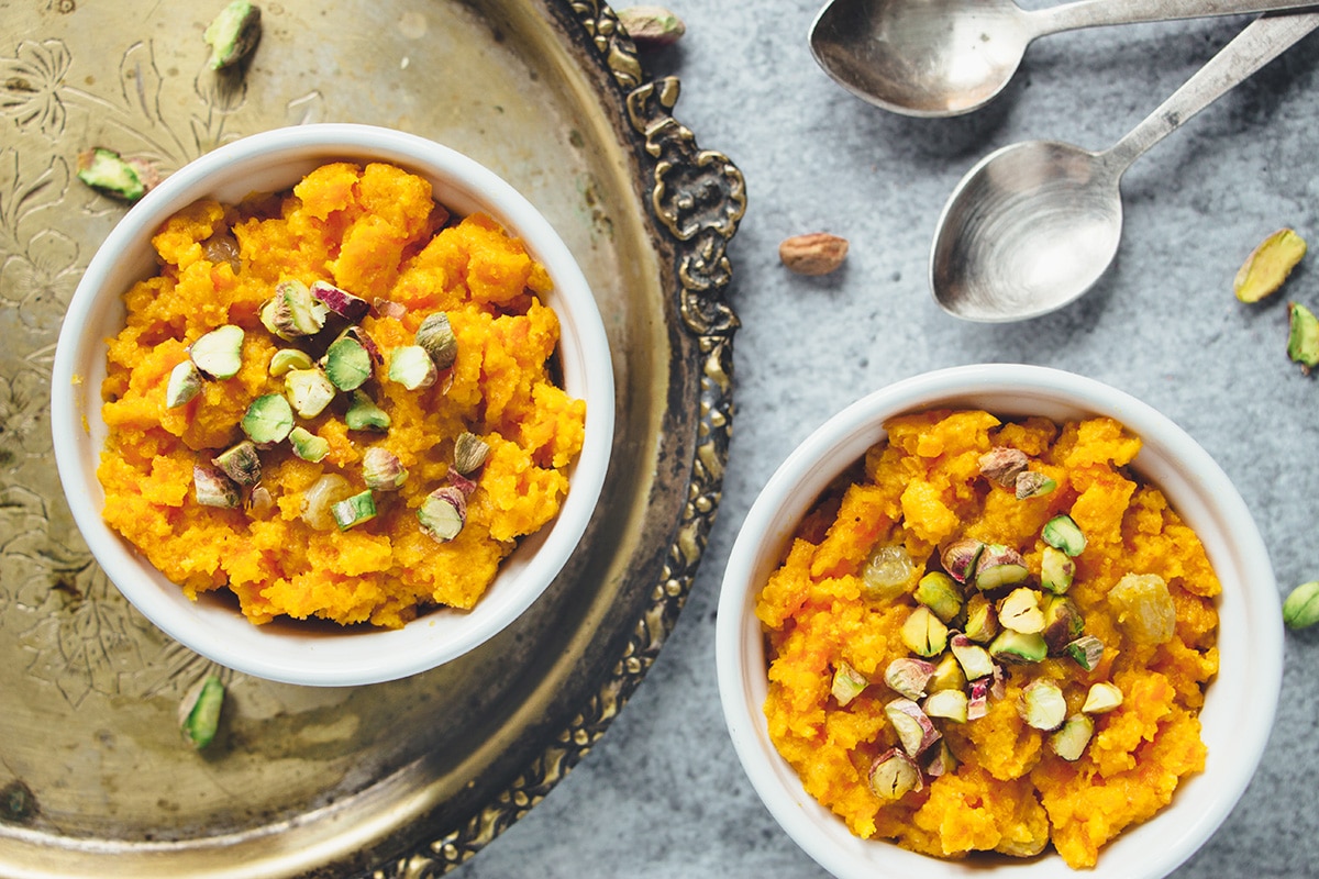 Gajar Ka Halwa is a well known Indian carrot dessert consisting of grated carrots, ghee, milk, sugar, and nuts. Infused with cardamom, it's truly amazing! | cookingtheglobe.com