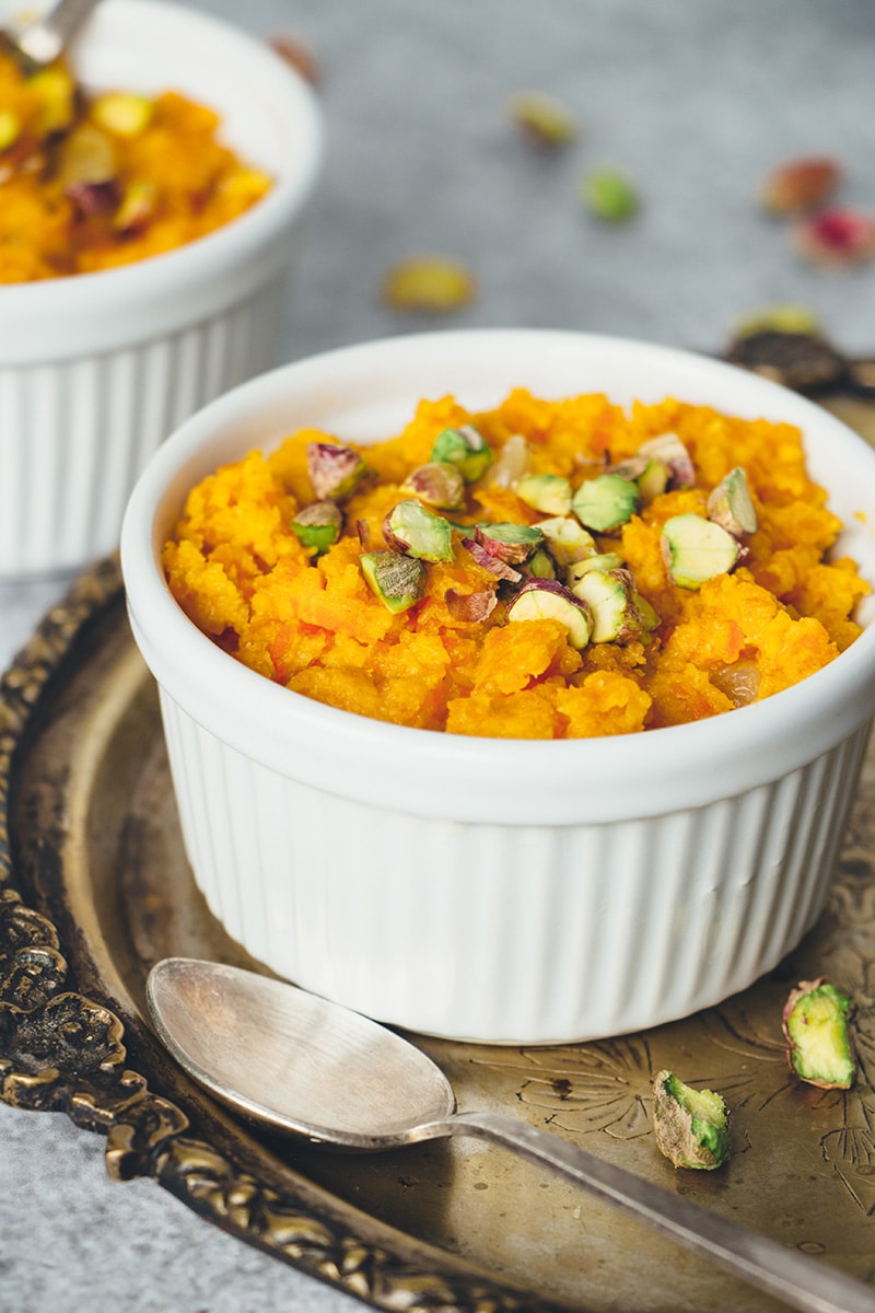Gajar Ka Halwa is a well known Indian carrot dessert consisting of grated carrots, ghee, milk, sugar, and nuts. Infused with cardamom, it's truly amazing! | cookingtheglobe.com