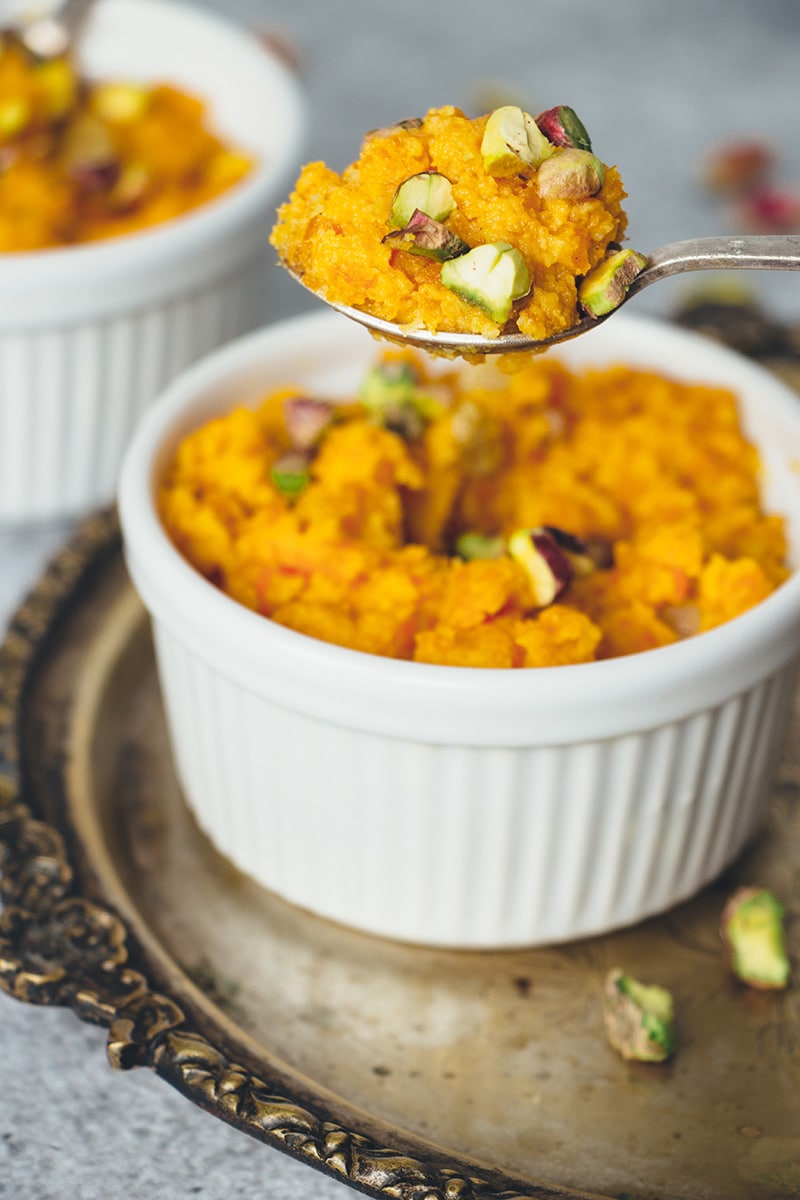 Gajar Ka Halwa is a well known Indian carrot dessert consisting of grated carrots, ghee, milk, sugar, and nuts. Infused with cardamom, it's truly amazing! | cookingtheglobe.com