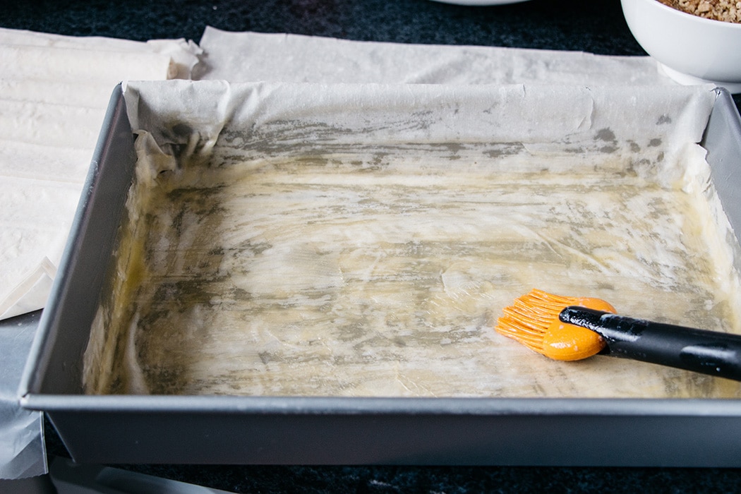 Brushing filo dough to make Turkish Baklava