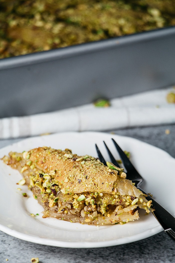 A Turkish baklava slice sprinkled with pistachios