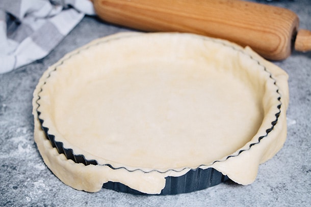 Lining a baking pan with dough