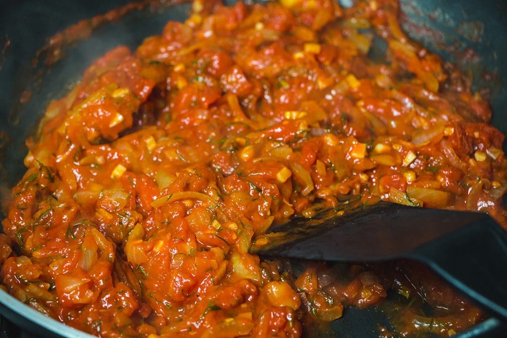 Frying the onion and canned tomato mixture