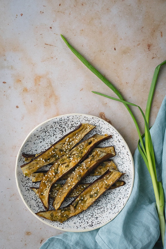 Japanese miso eggplant sprinkled with white sesame seeds and served on a plate