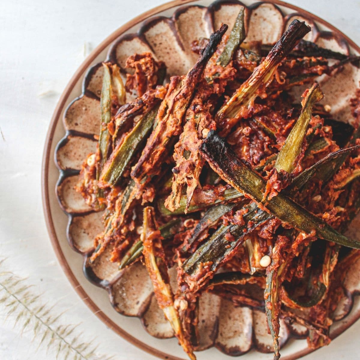 Overhead image of tan plate with fried okra stacked on top