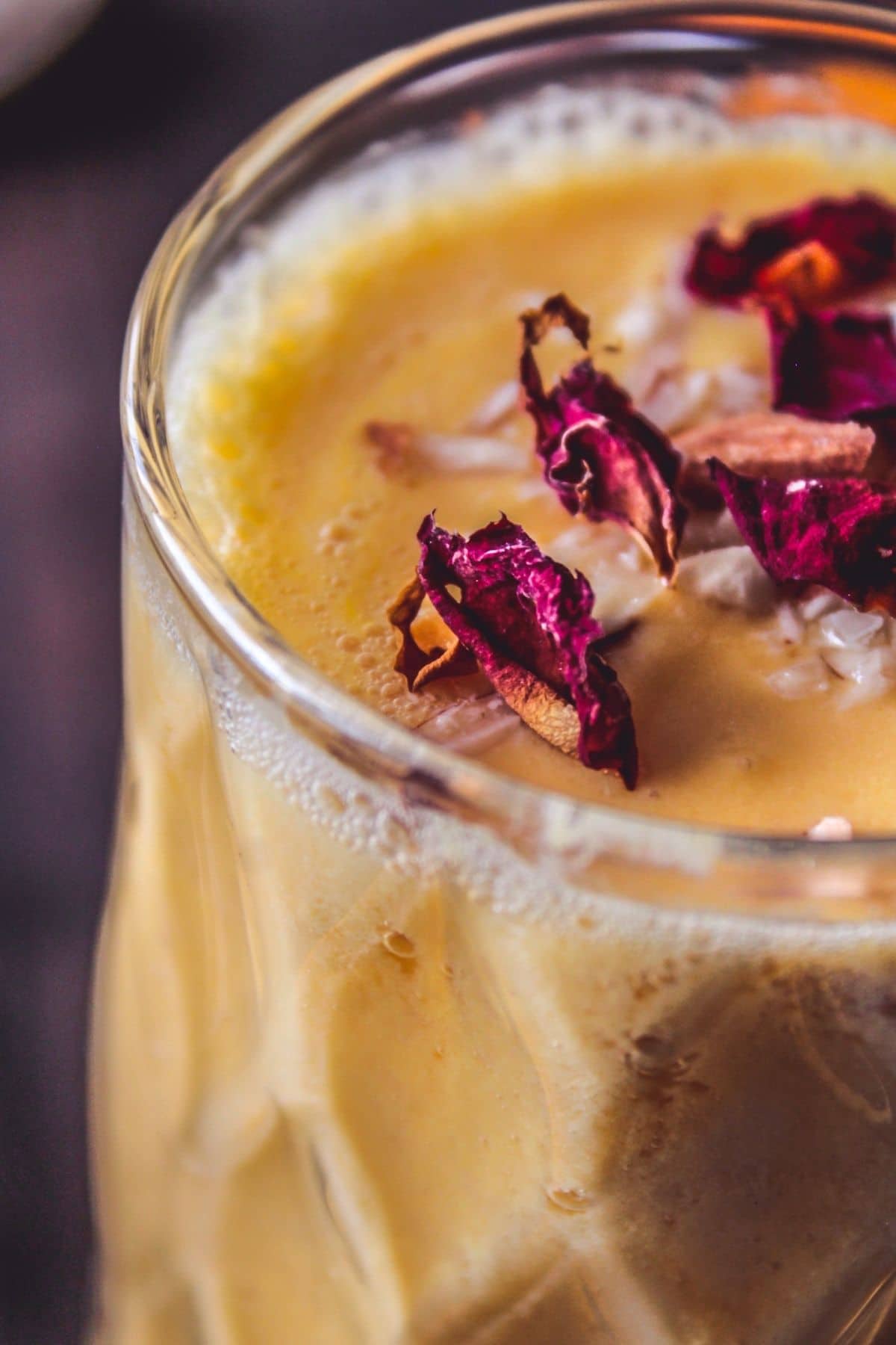 Crinkle glass with mango lassi and rose petals on top