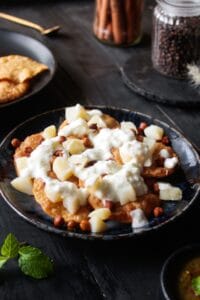 Topping papdi chaat with curd