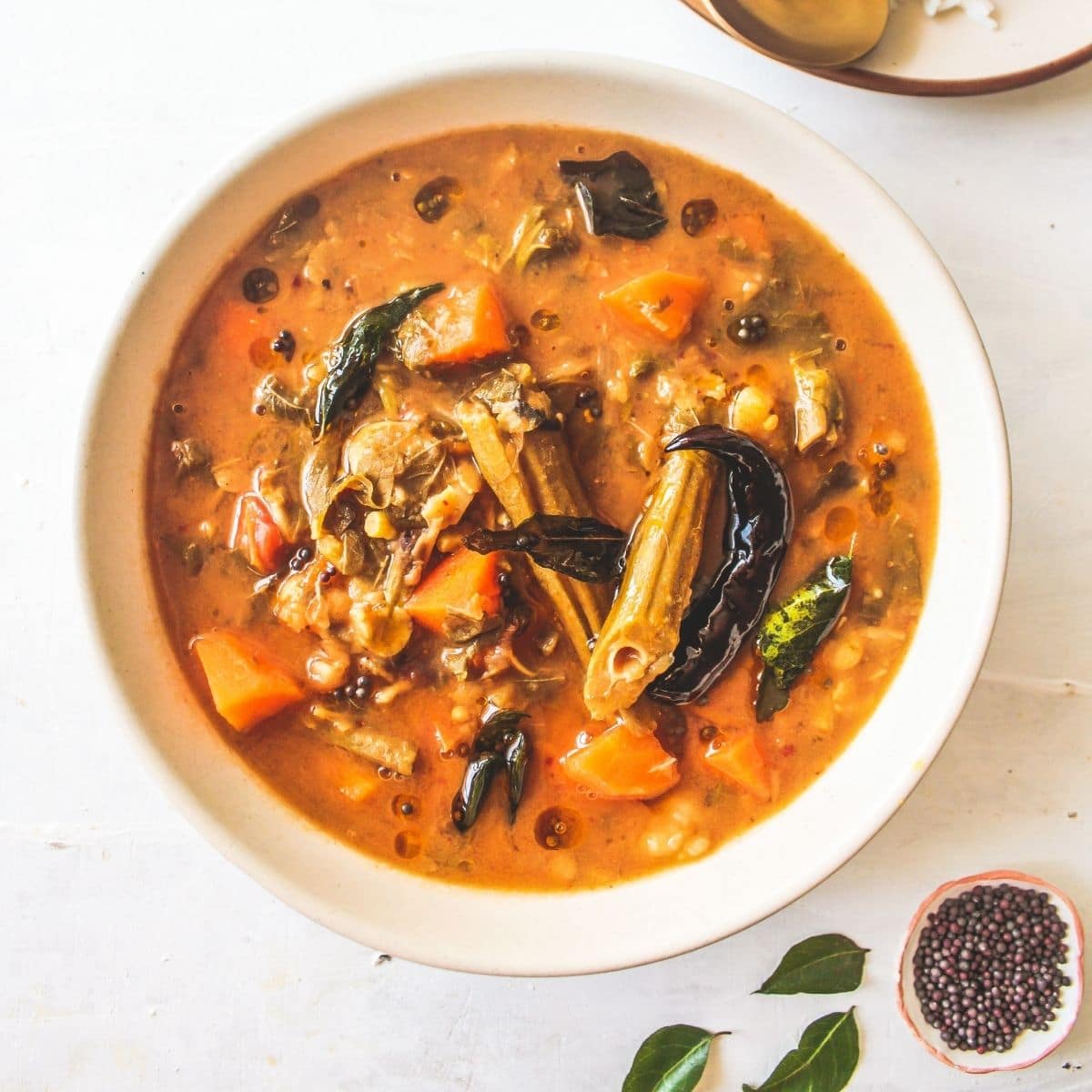 White bowl filled with sambar stew