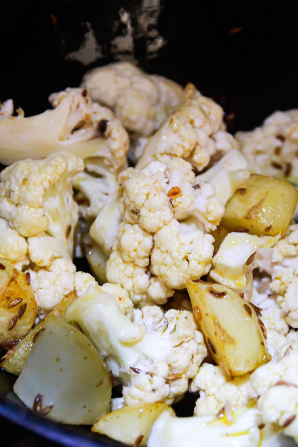 Cauliflower and potato pieces in skillet