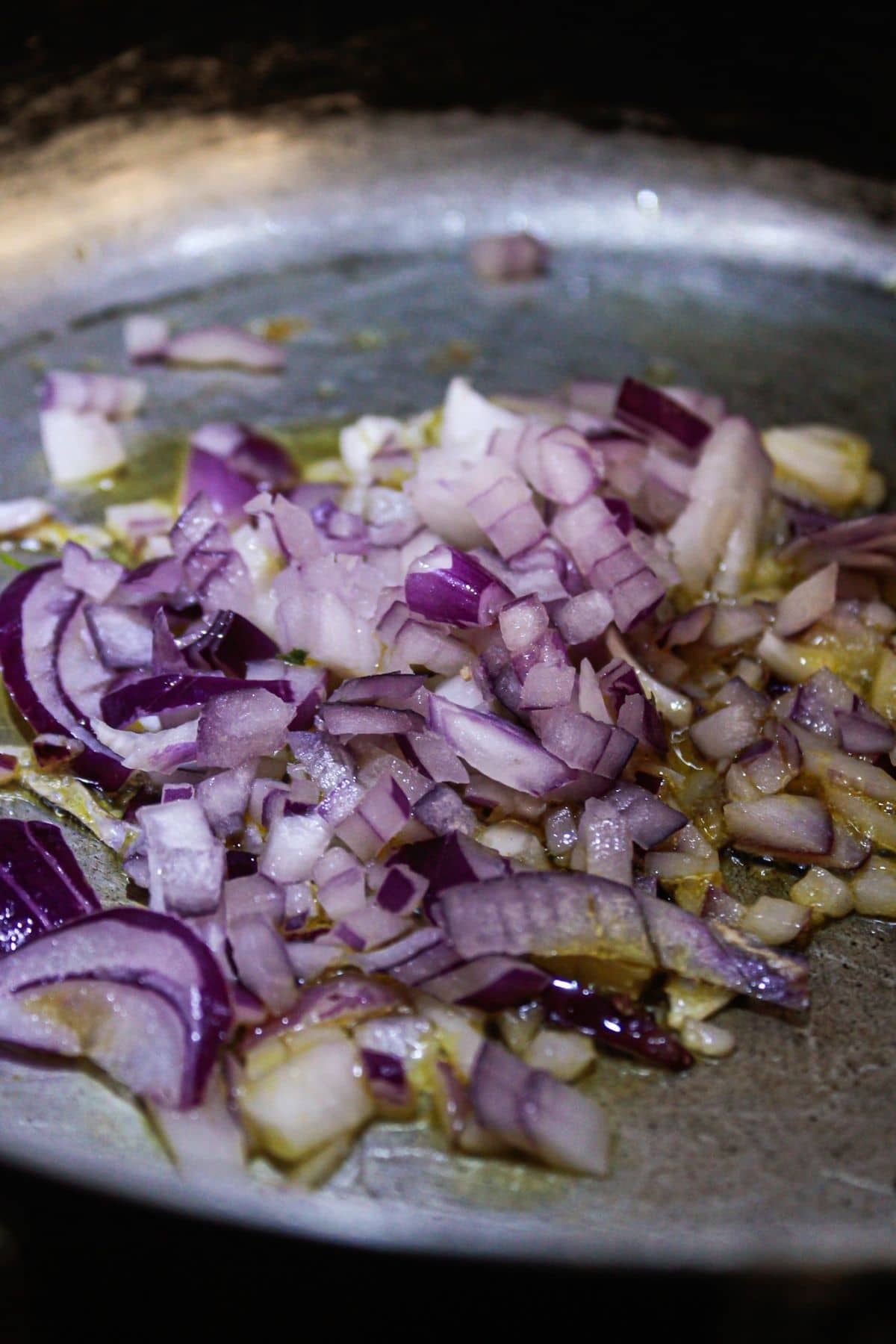 Red onions in skillet with oil