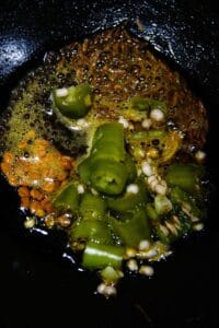 Oil seeds and chiles in skillet