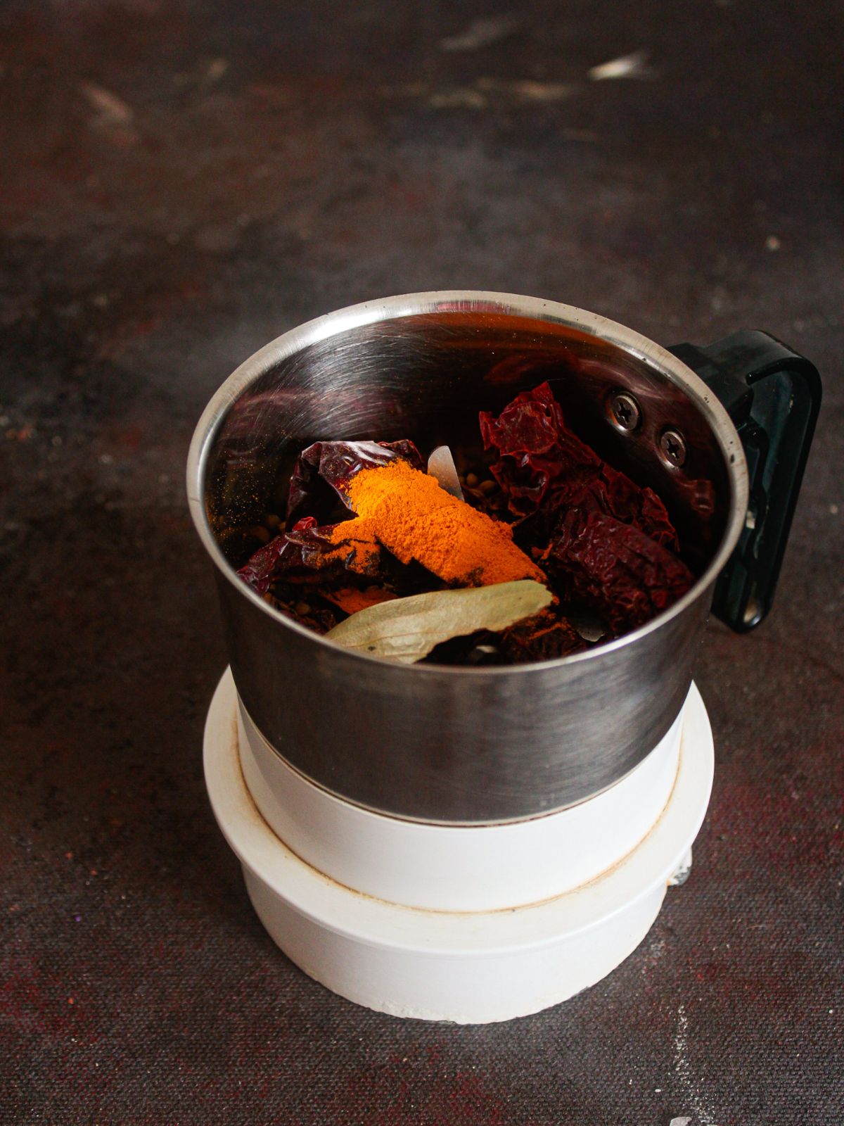 spice grinder filled with roasted spices before grinding