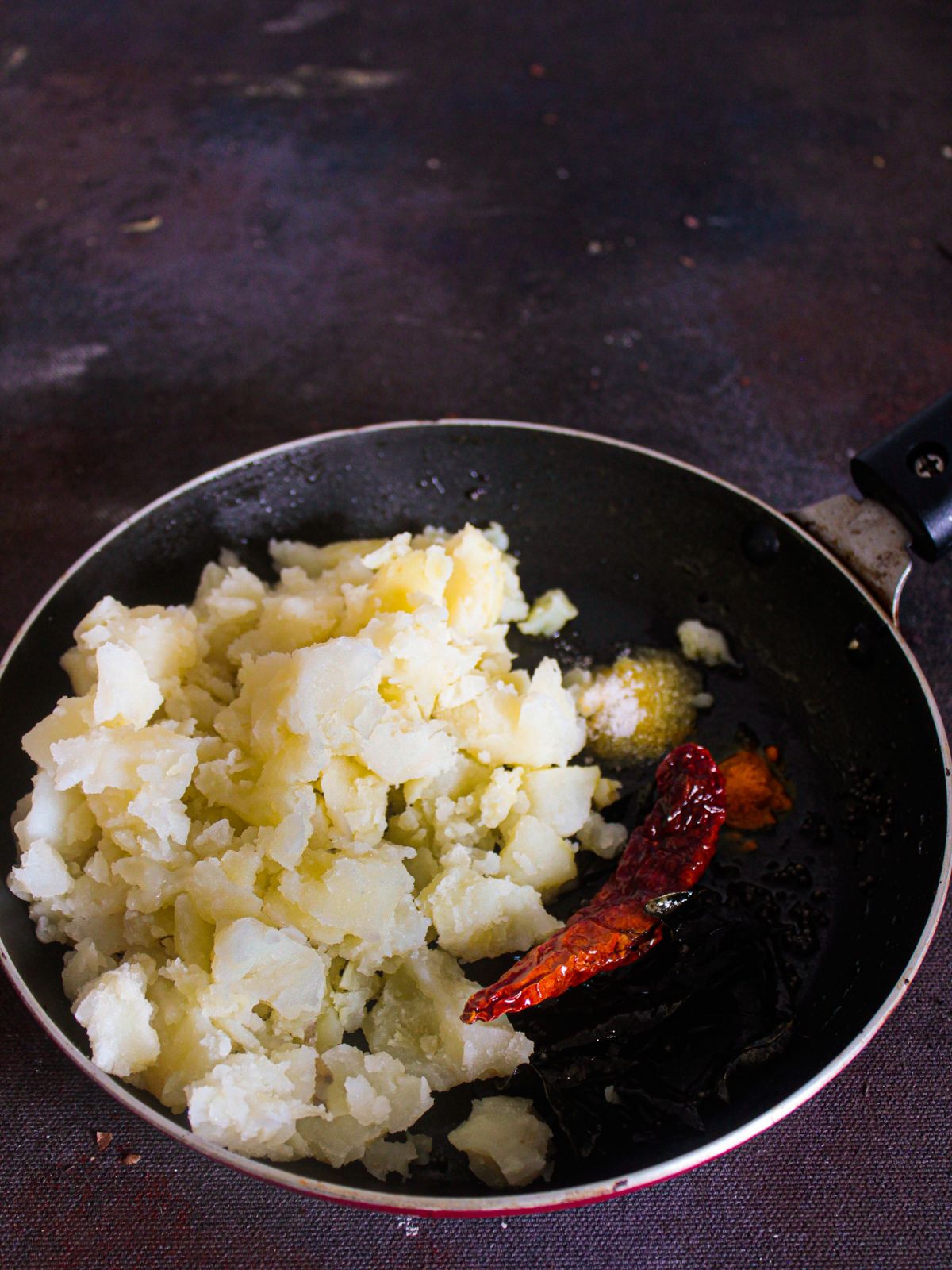 Skillet of mashed potatoes with red chili