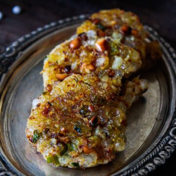 Stack of tapico fritters on oval silver platter