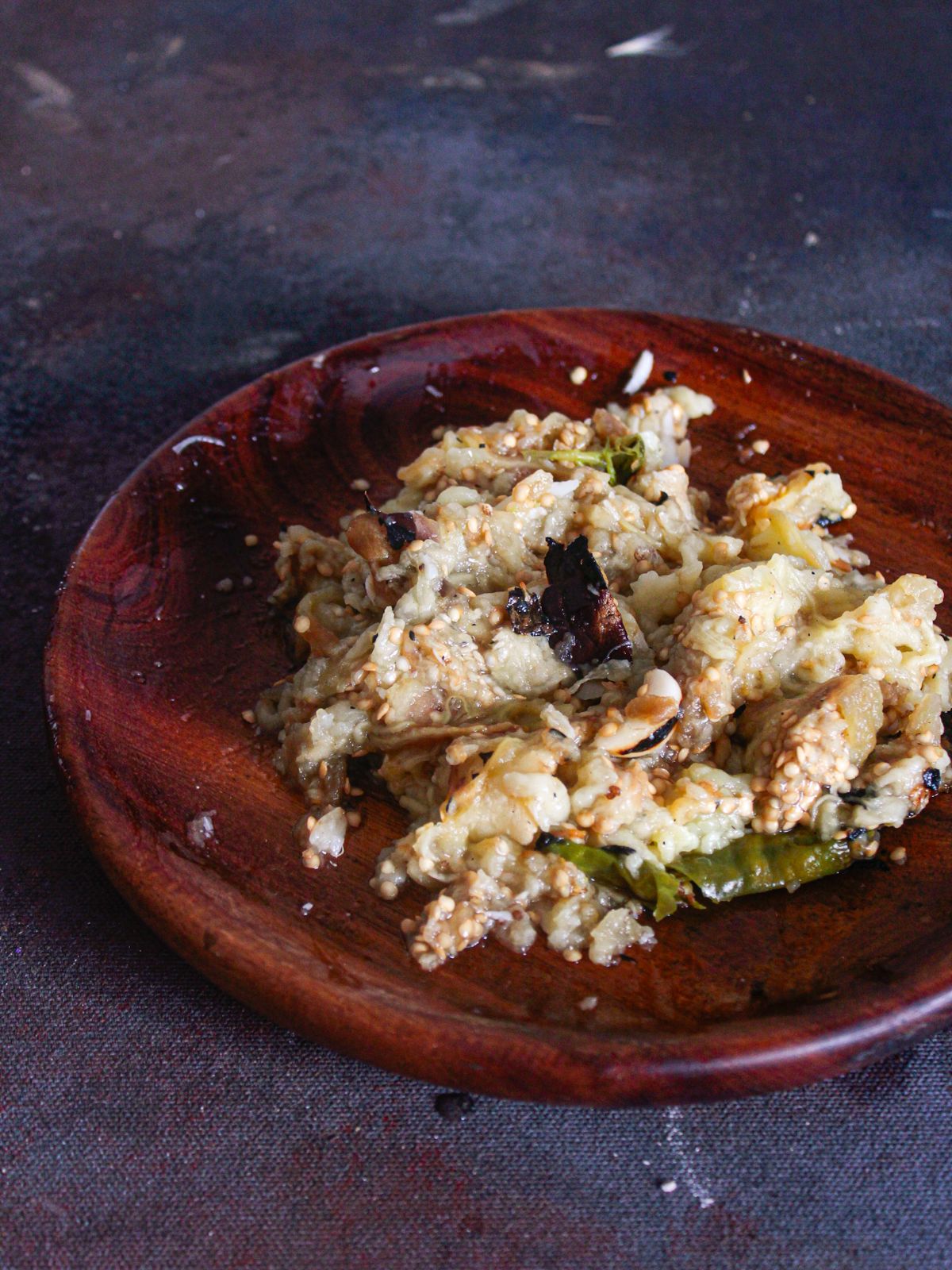 Wooden bowl with mashed eggplant and chiles