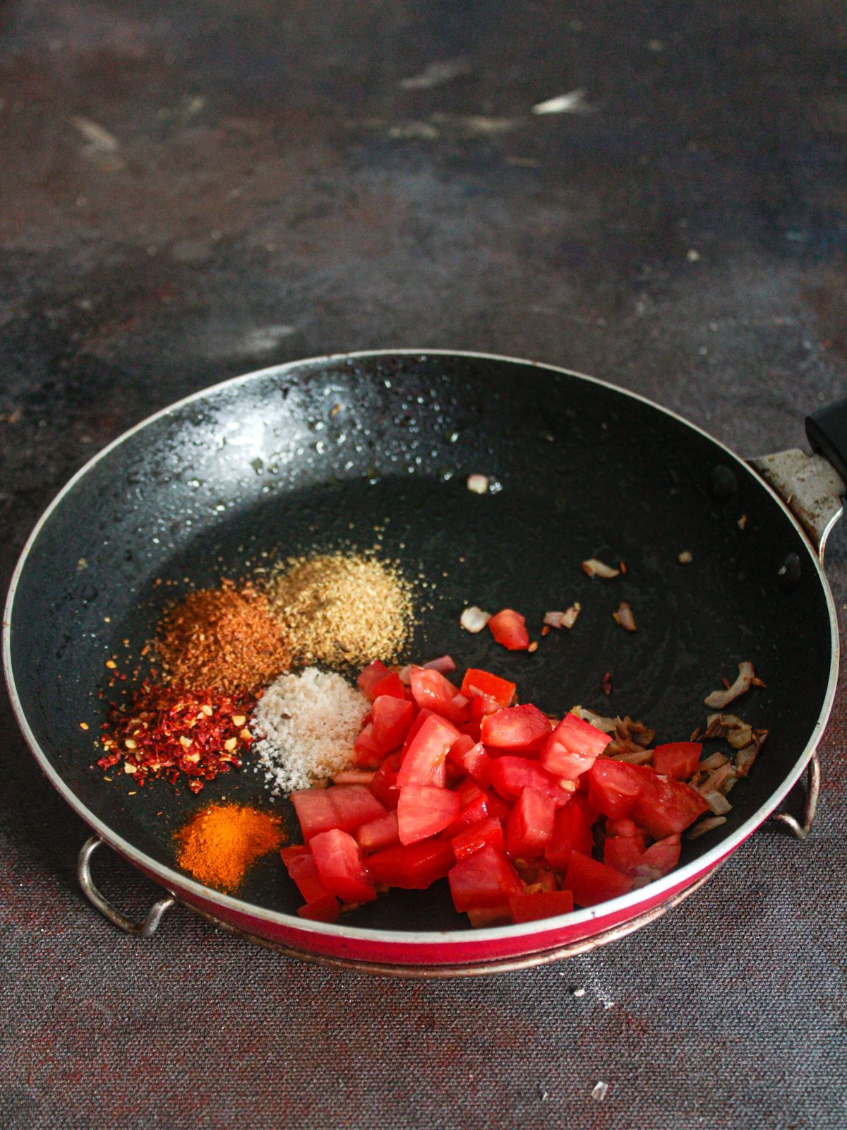 Tomatoes and spices in skillet
