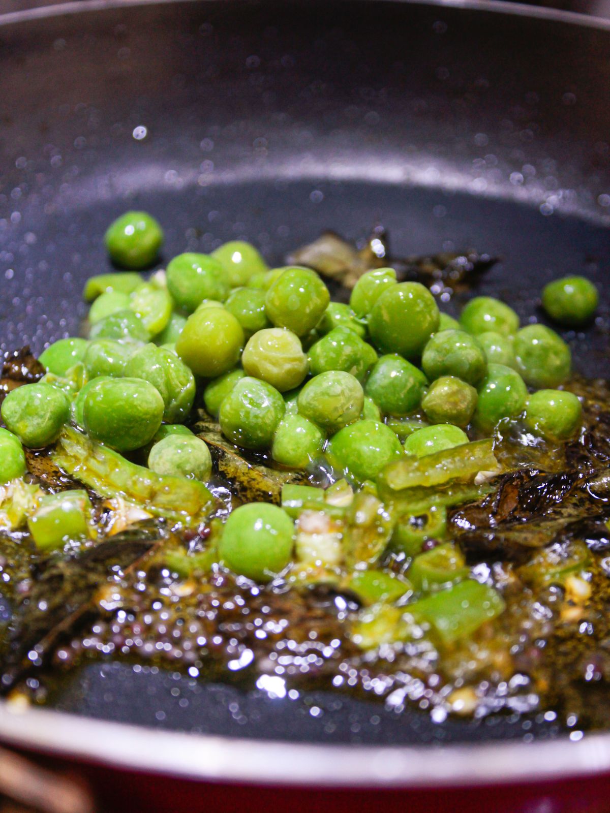 peas and green chiles in oil in skillet