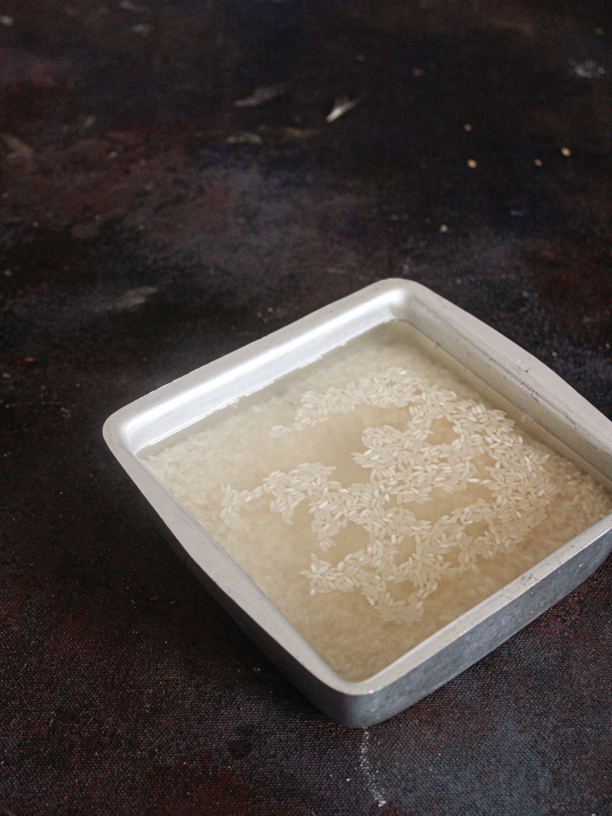 square white bowl of rice in water