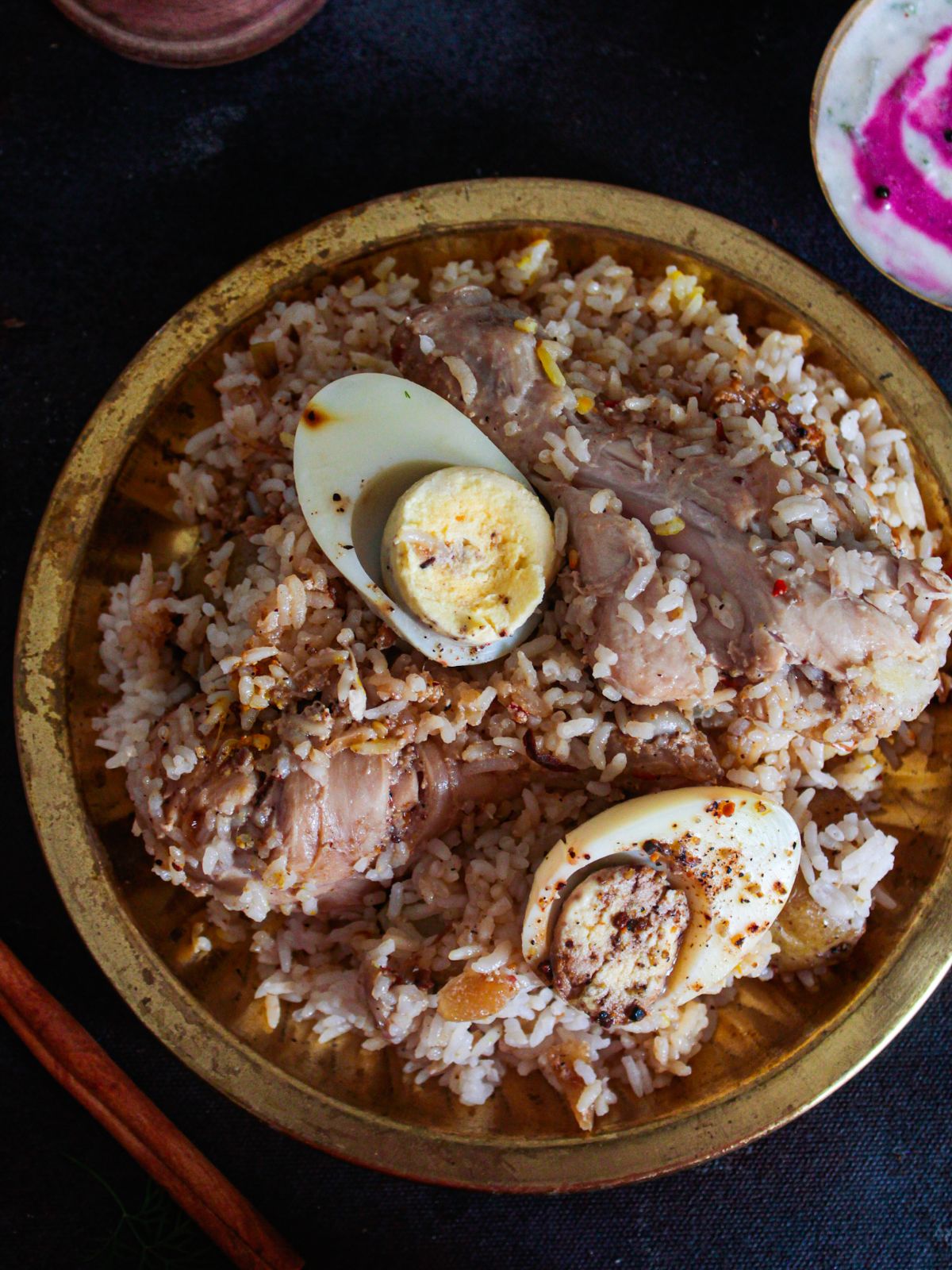 kolkata chicken biryani in bowl topped with hard boiled egg