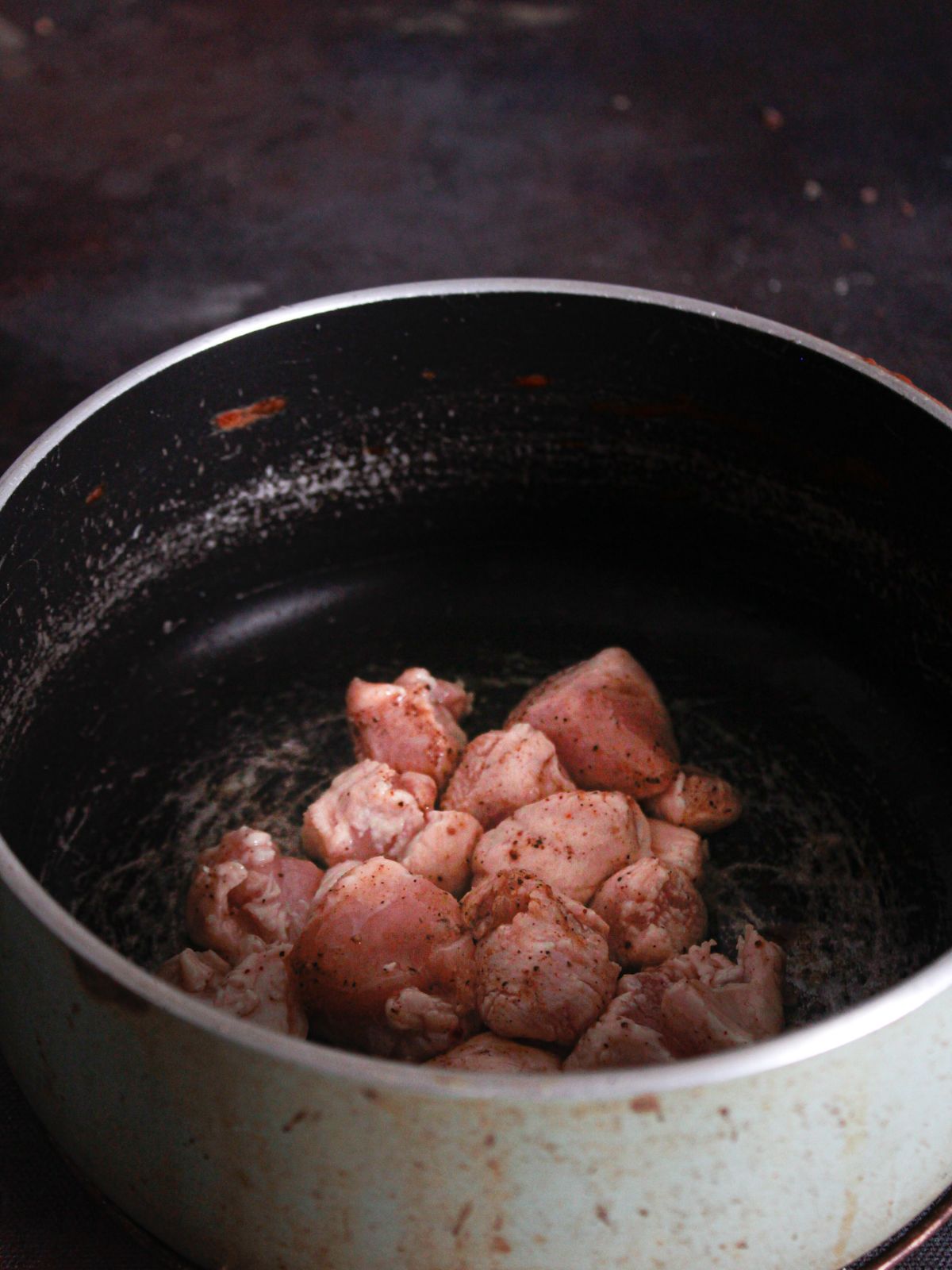 chicken breasts pieces in large stockpot of oil