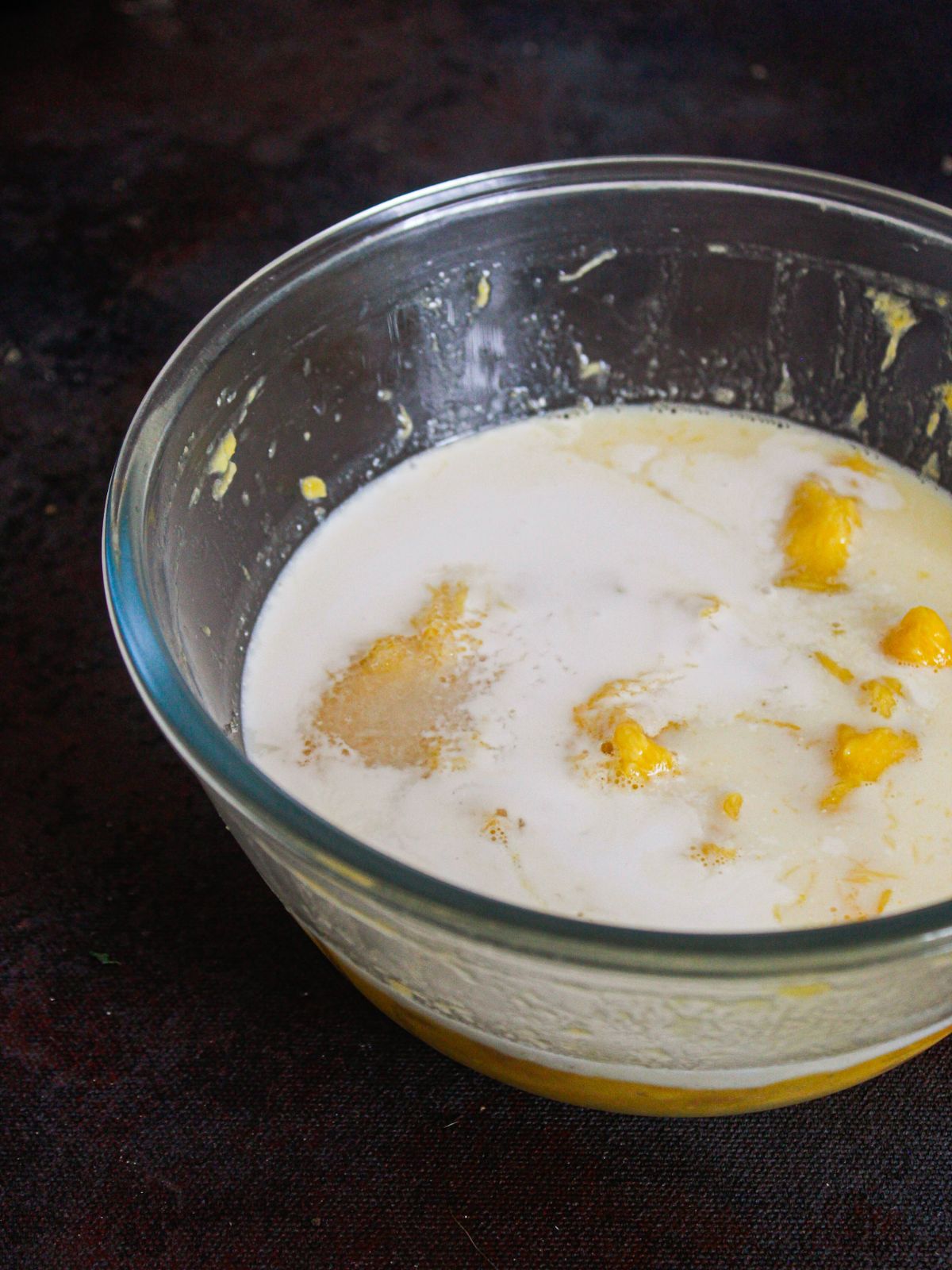 glass bowl filled with milk and mango
