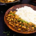 chole chickpea curry in brown bowl with rice