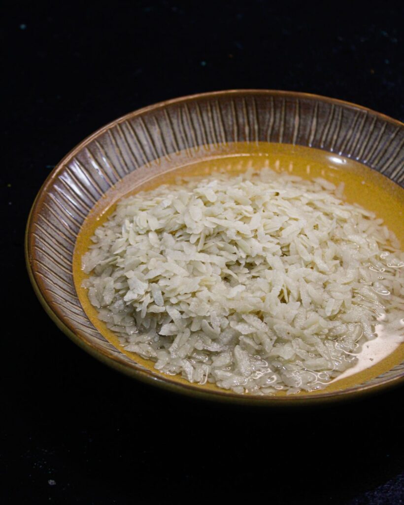Take poha/flattened rice in a bowl and add enough water to cover it. Let it sit in the water for 2 minutes.