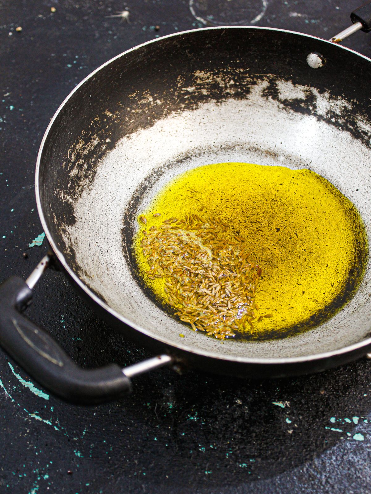 skillet with oil and aromatics