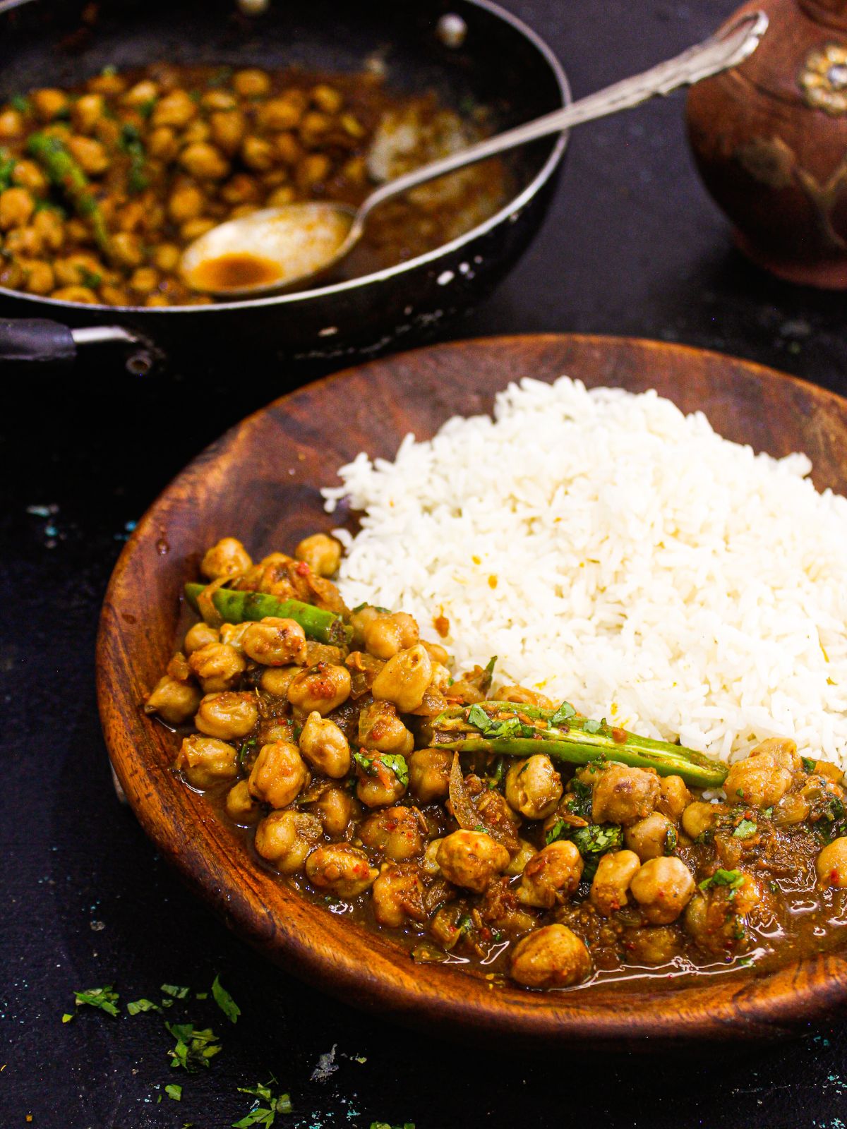 brown bowl of chole chickpea curry and rice