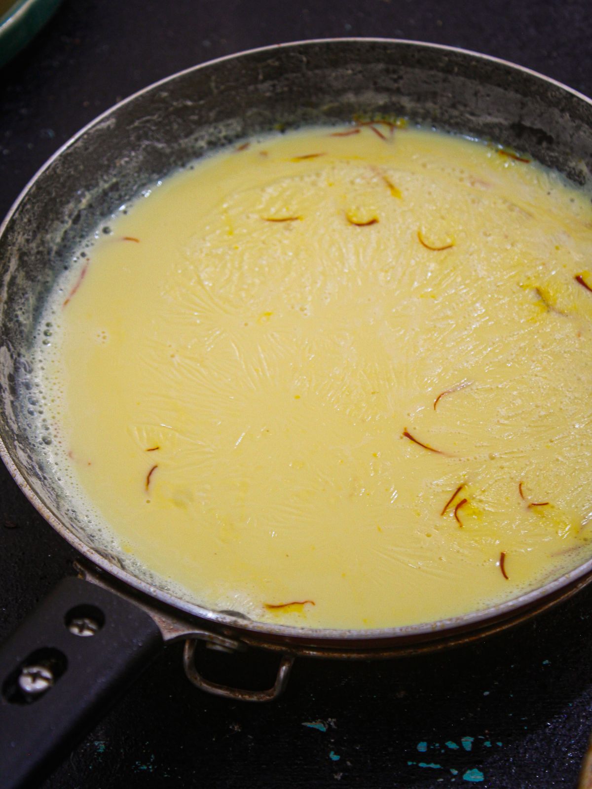 Boil the milk and add saffron and rose water.