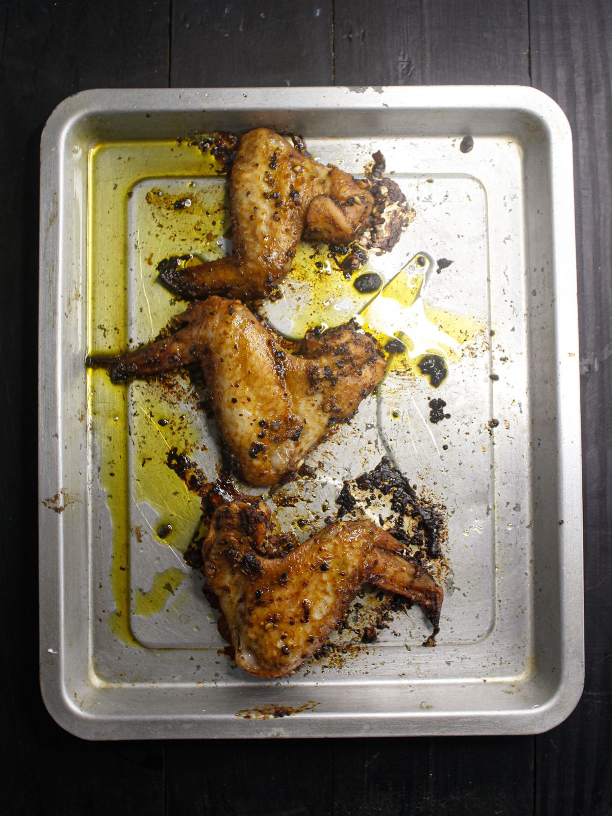 Baked chicken wings served with chopped basil